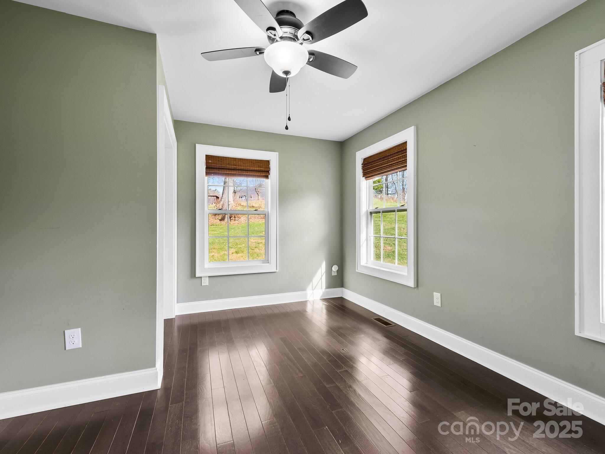 3367 Thickety Road Clyde, NC 28721 - Photo 14 of 21 a view of an empty room with wooden floor and a window
