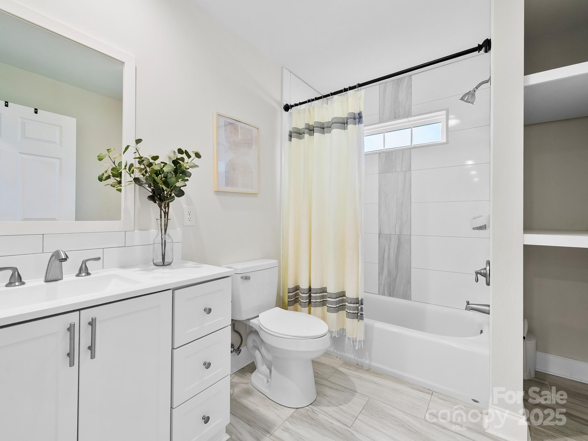 3367 Thickety Road Clyde, NC 28721 - Photo 16 of 21 a bathroom with a sink a toilet and a large mirror