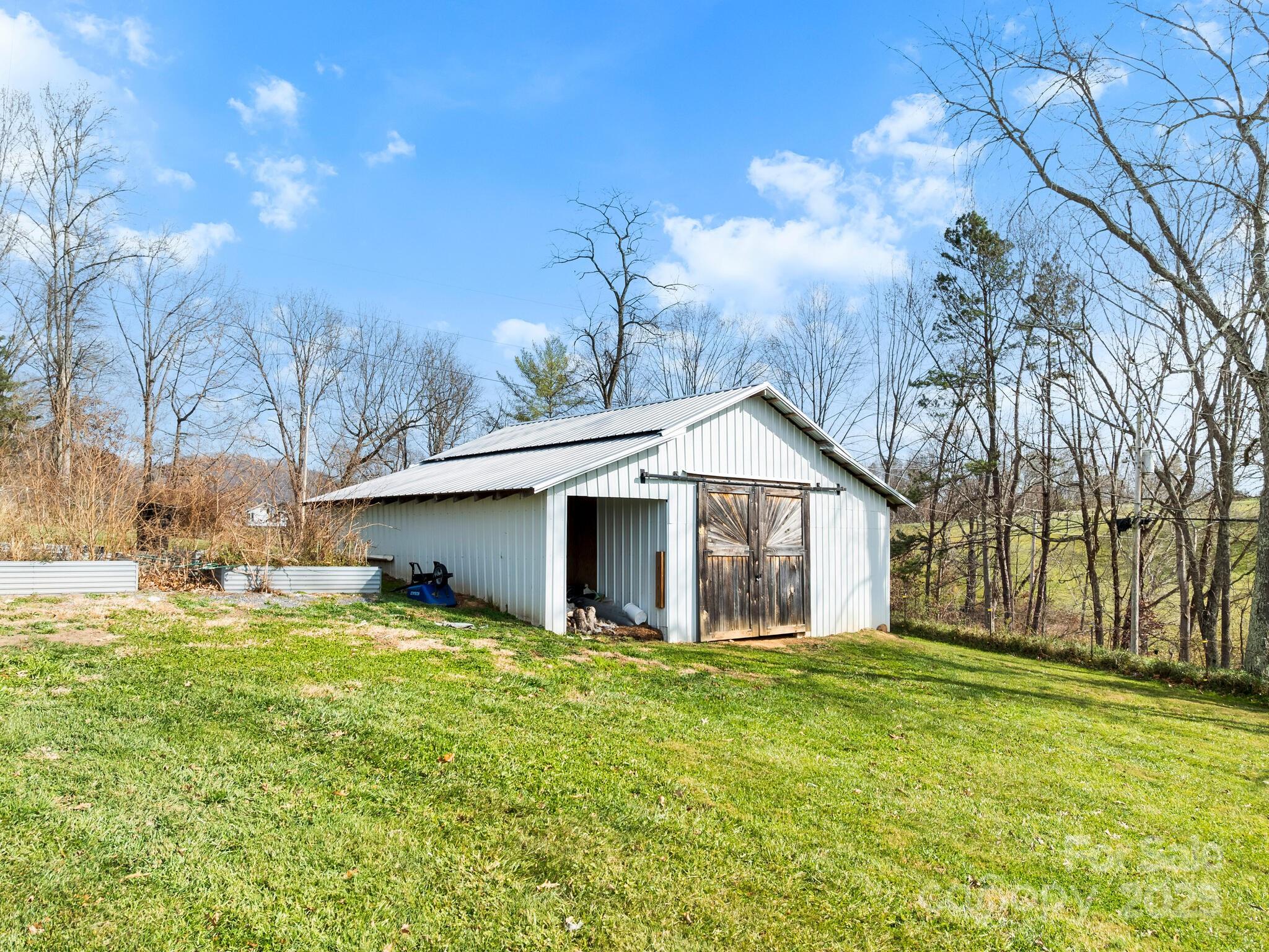 3367 Thickety Road Clyde, NC 28721 - Photo 19 of 21 a front view of house with yard and trees in the background