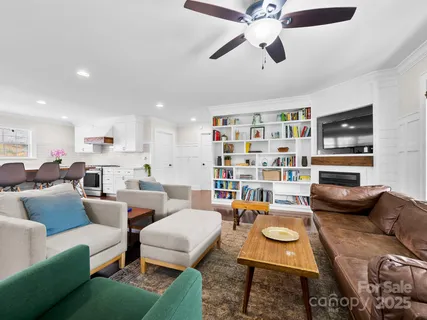 a living room with furniture a rug and a flat screen tv