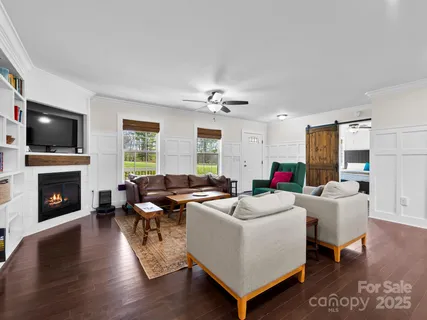 a living room with fireplace furniture and a flat screen tv