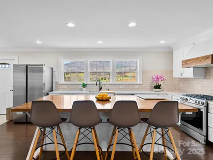 a view of a dining room with furniture and a potted plant