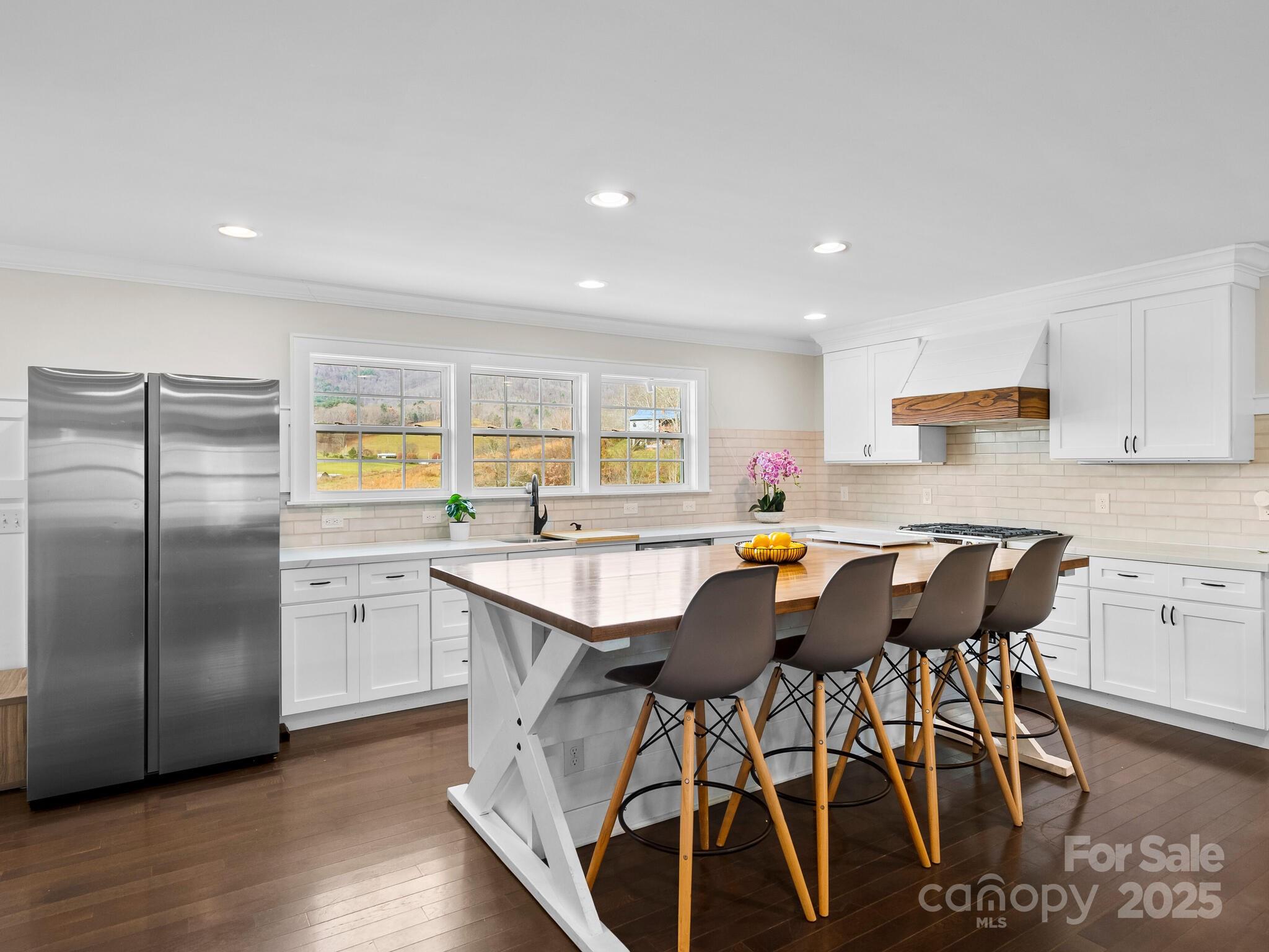 3367 Thickety Road Clyde, NC 28721 - Photo 8 of 21 a kitchen with stainless steel appliances kitchen island granite countertop a table chairs sink and cabinets