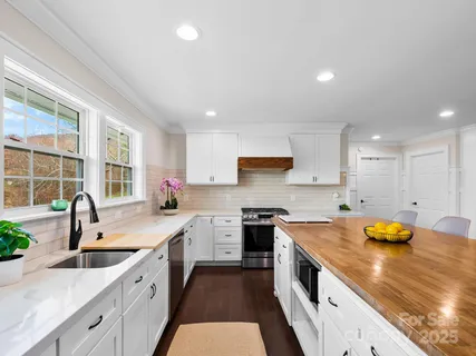 a kitchen with a sink a stove and cabinets