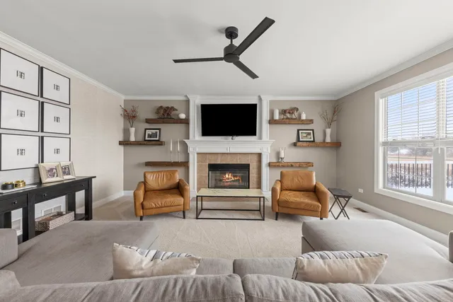 a living room with furniture a fireplace and a flat screen tv