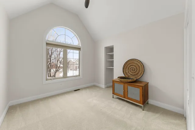 a view of a livingroom with wooden floor and a window