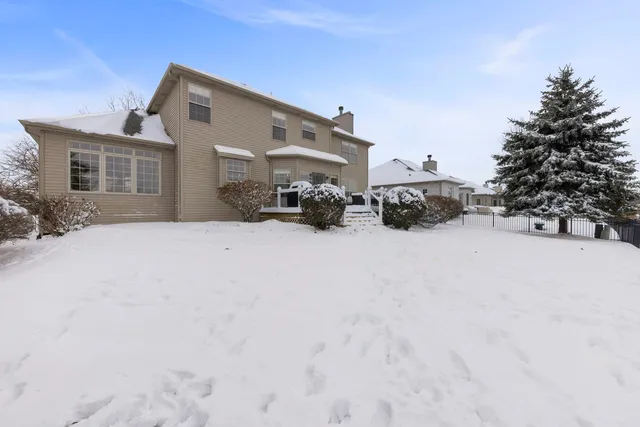 a view of a house with snow in the backyard