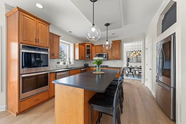 a kitchen with stainless steel appliances granite countertop a stove a sink refrigerator and a microwave