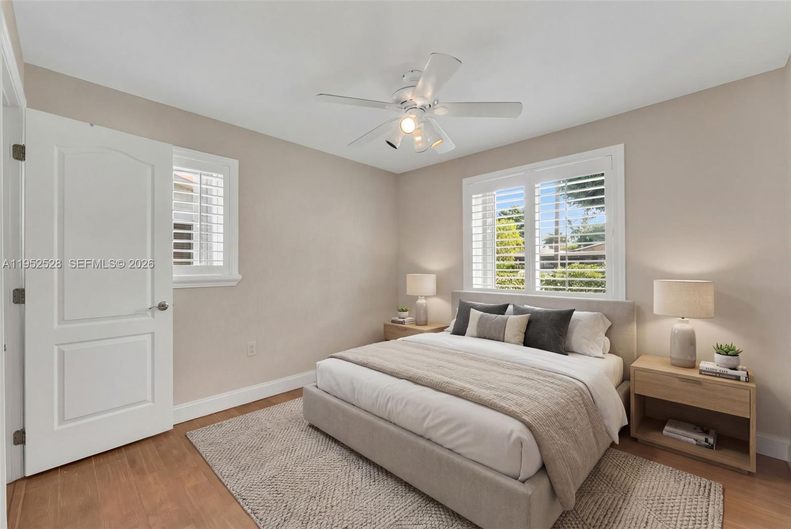 9567 Southwest 59th Terrace Miami, FL 33173 - Photo 18 of 36 a bedroom with a large bed and a chandelier