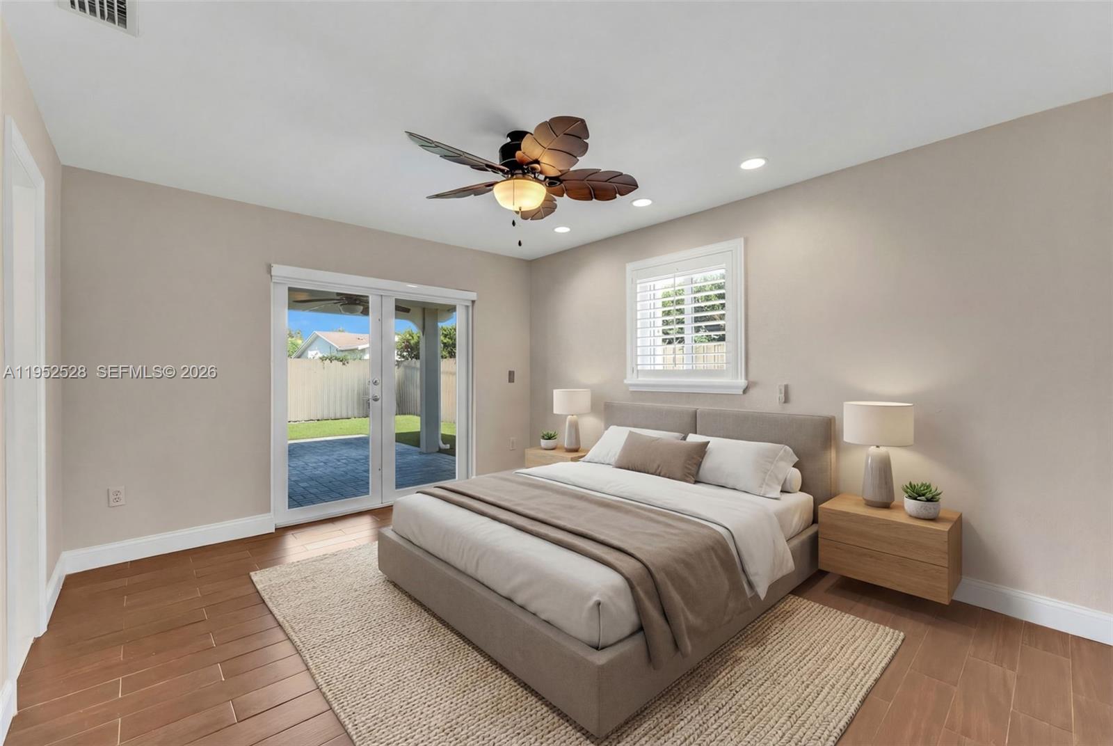 9567 Southwest 59th Terrace Miami, FL 33173 - Photo 21 of 36 a bedroom with bed and a chandelier