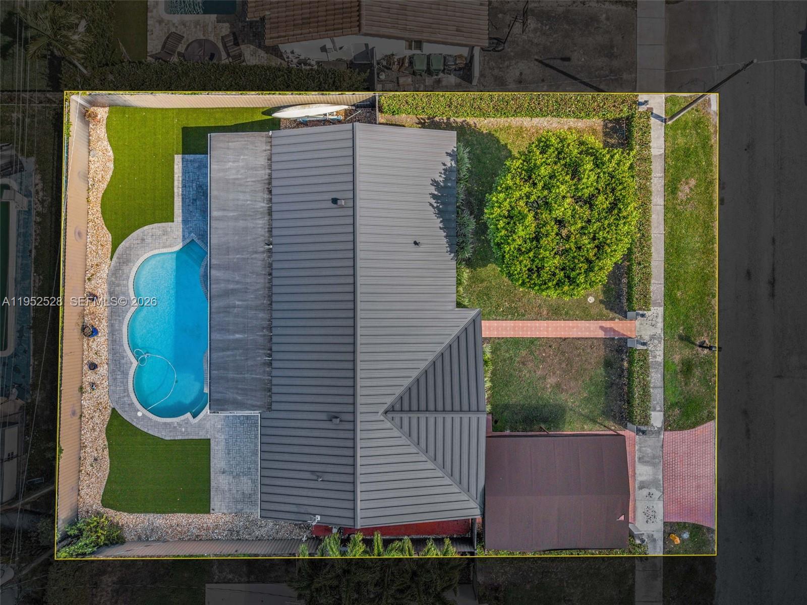 9567 Southwest 59th Terrace Miami, FL 33173 - Photo 33 of 36 a view of a swimming pool with a yard