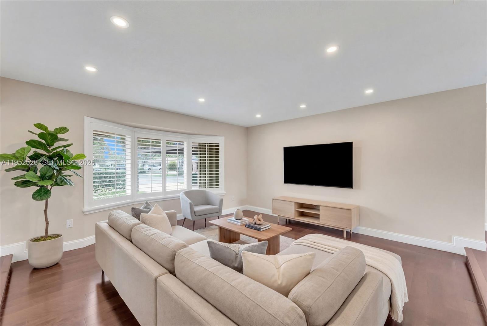 9567 Southwest 59th Terrace Miami, FL 33173 - Photo 7 of 36 a living room with furniture and a flat screen tv