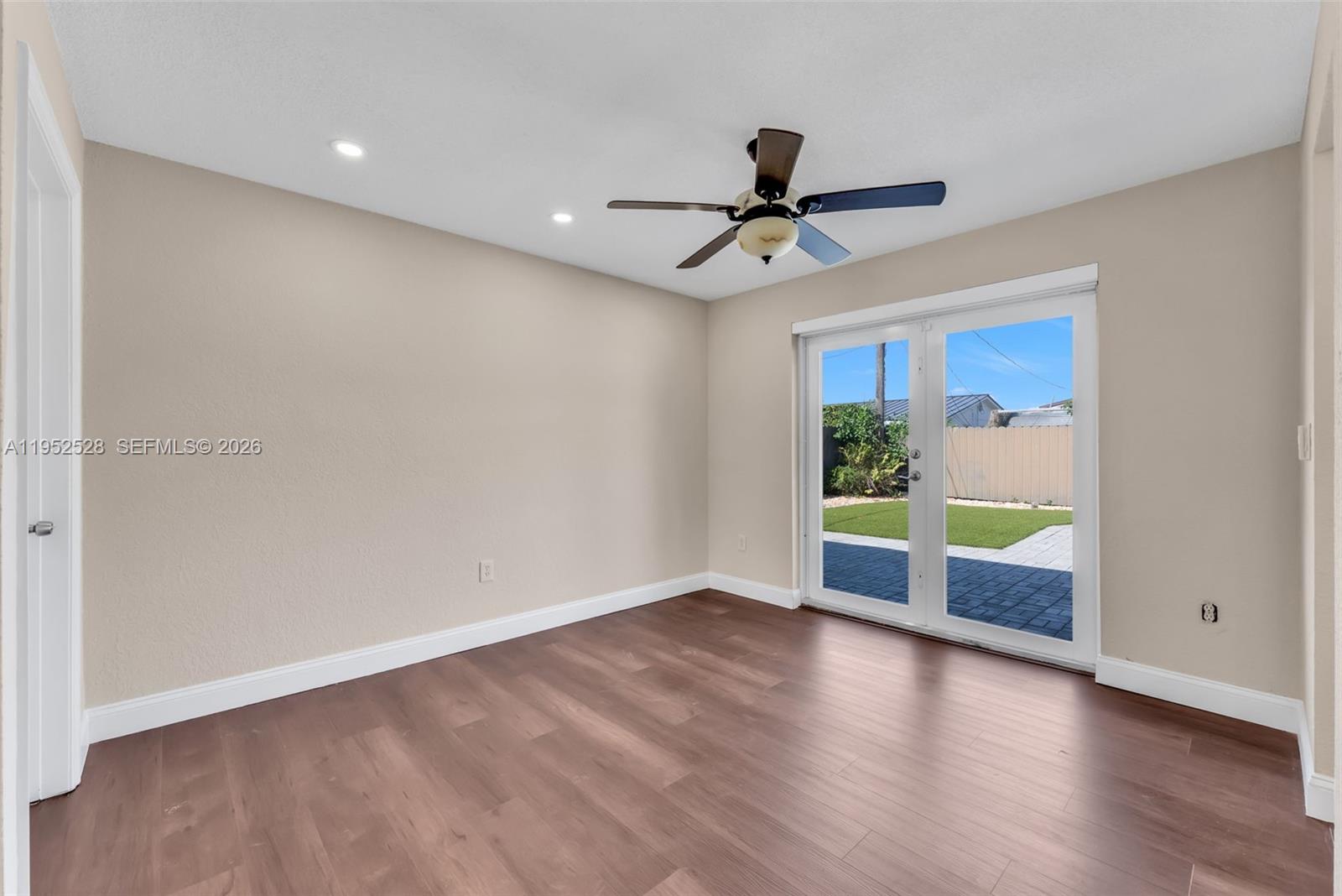9567 Southwest 59th Terrace Miami, FL 33173 - Photo 9 of 36 a view of an empty room with window and wooden floor