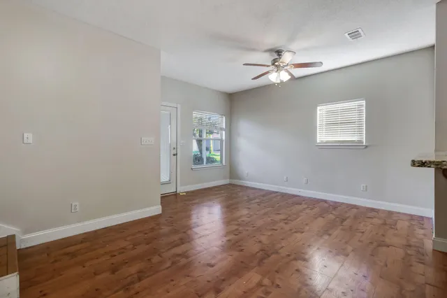 wooden floor in an empty room with a window
