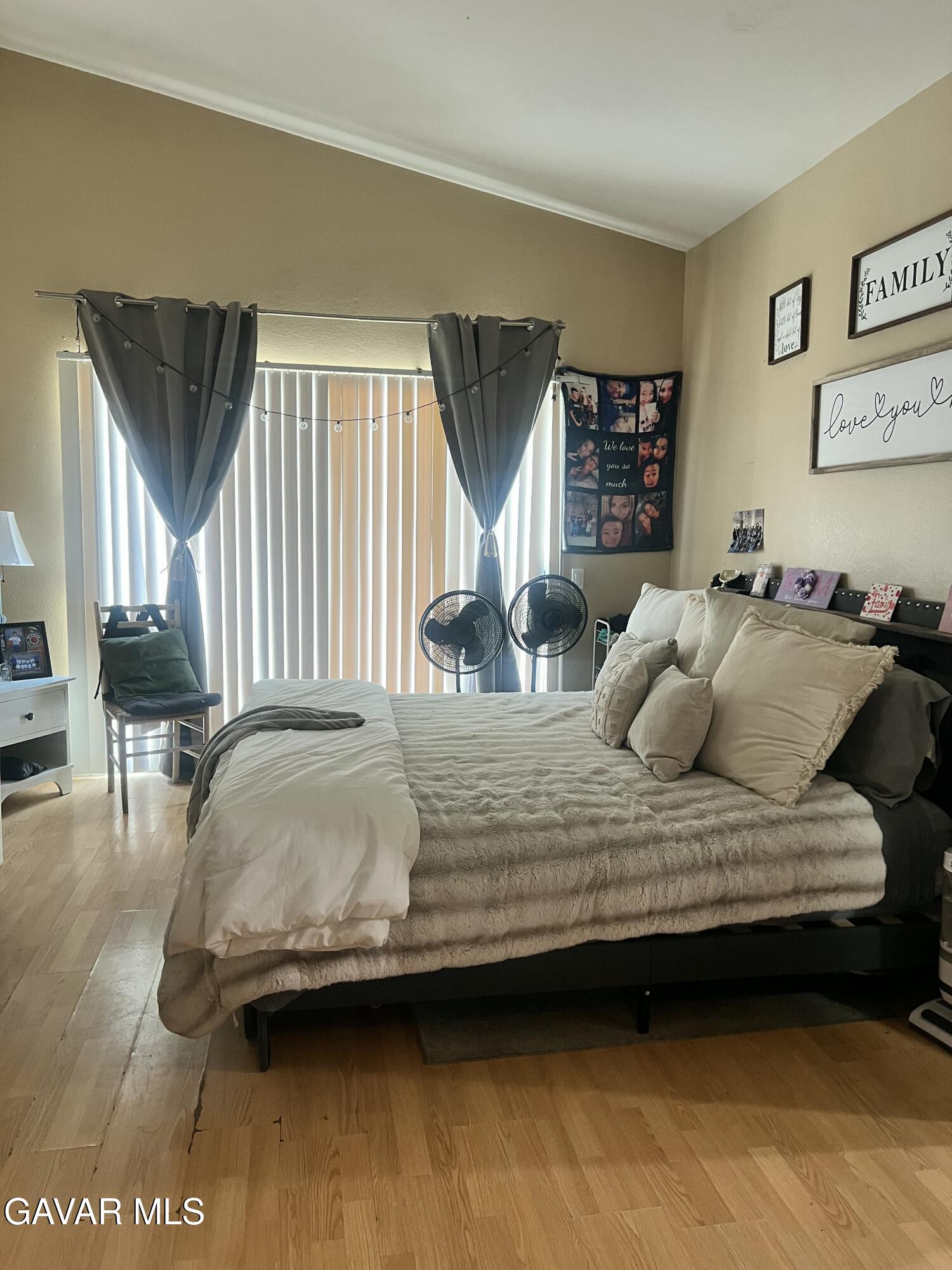 2428 Dixie Street Rosamond, CA 93560 - Photo 16 of 29 a bedroom with a bed a mirror and lamp