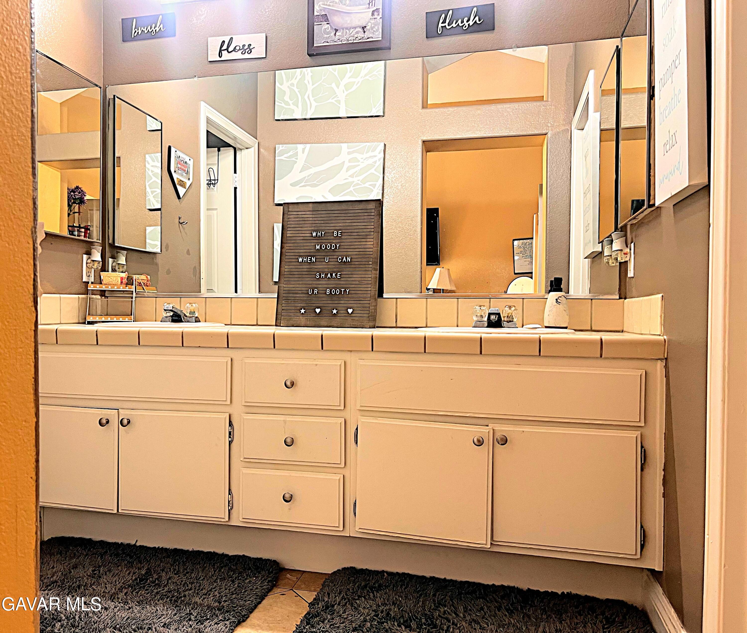 2428 Dixie Street Rosamond, CA 93560 - Photo 17 of 29 a bathroom with a sink and a mirror