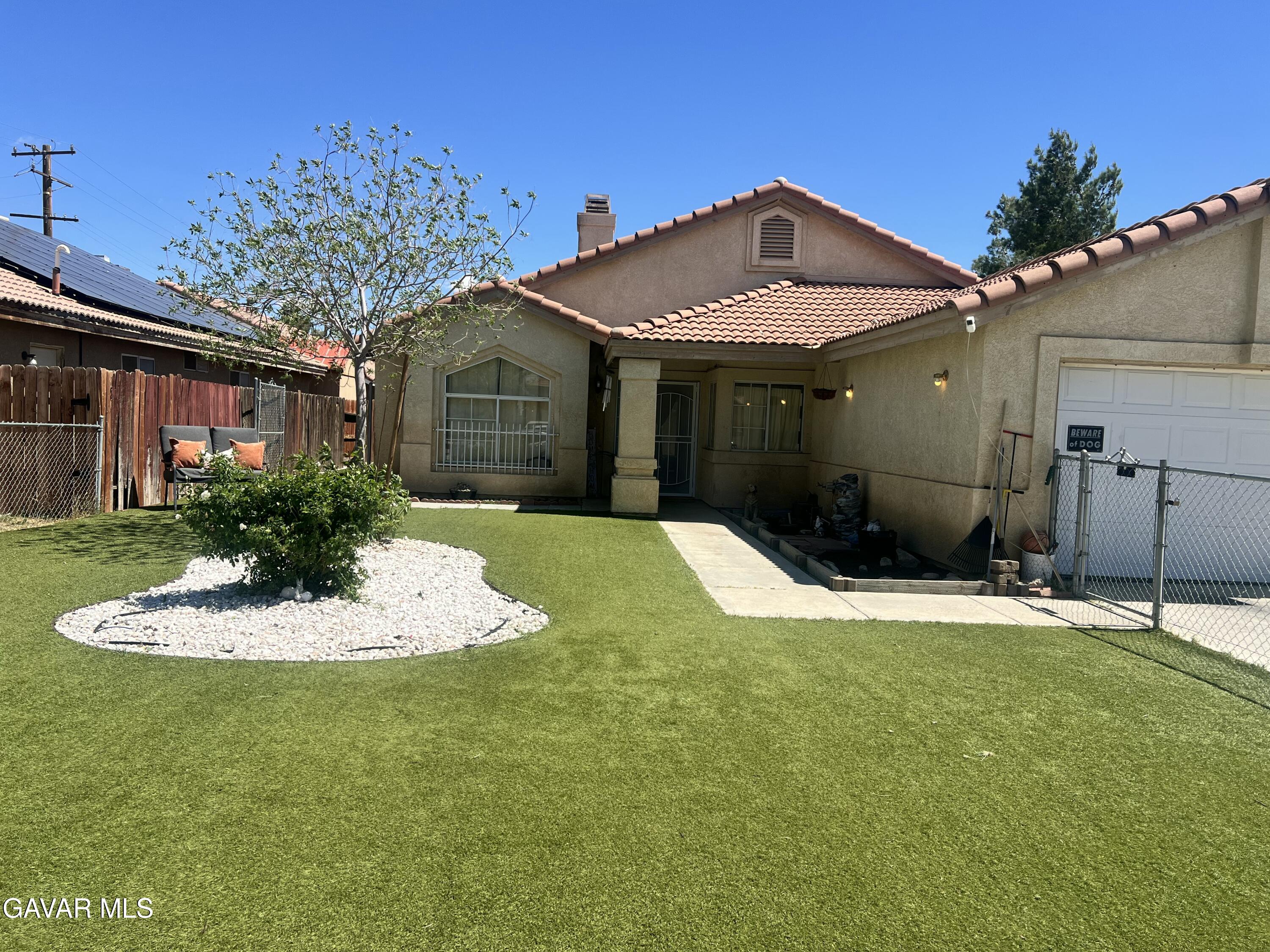 2428 Dixie Street Rosamond, CA 93560 - Photo 5 of 29 a front view of a house with a yard
