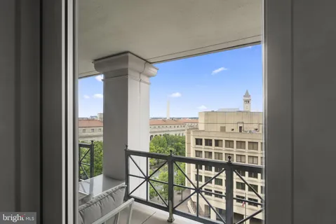 a view of a balcony with a floor to ceiling window and wooden floor