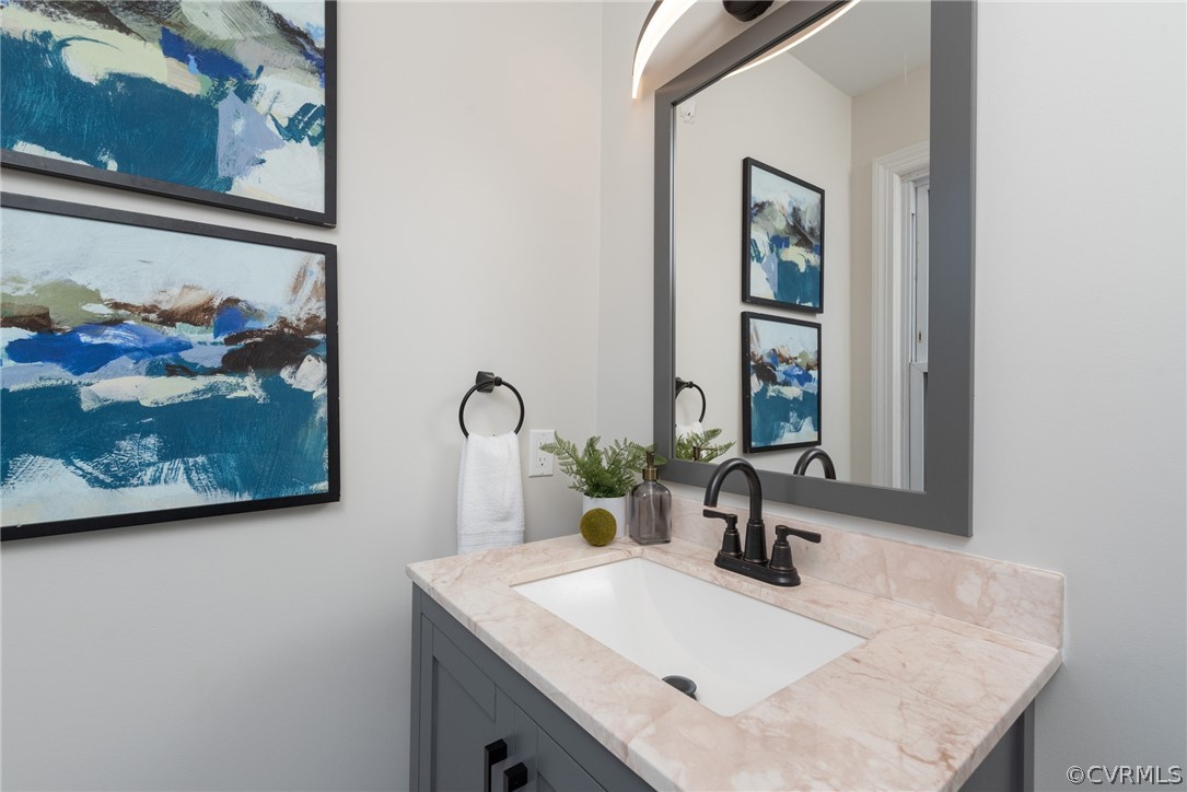 11711 Robious Road Midlothian, VA 23113 - Photo 13 of 32 a bathroom with a sink and a mirror