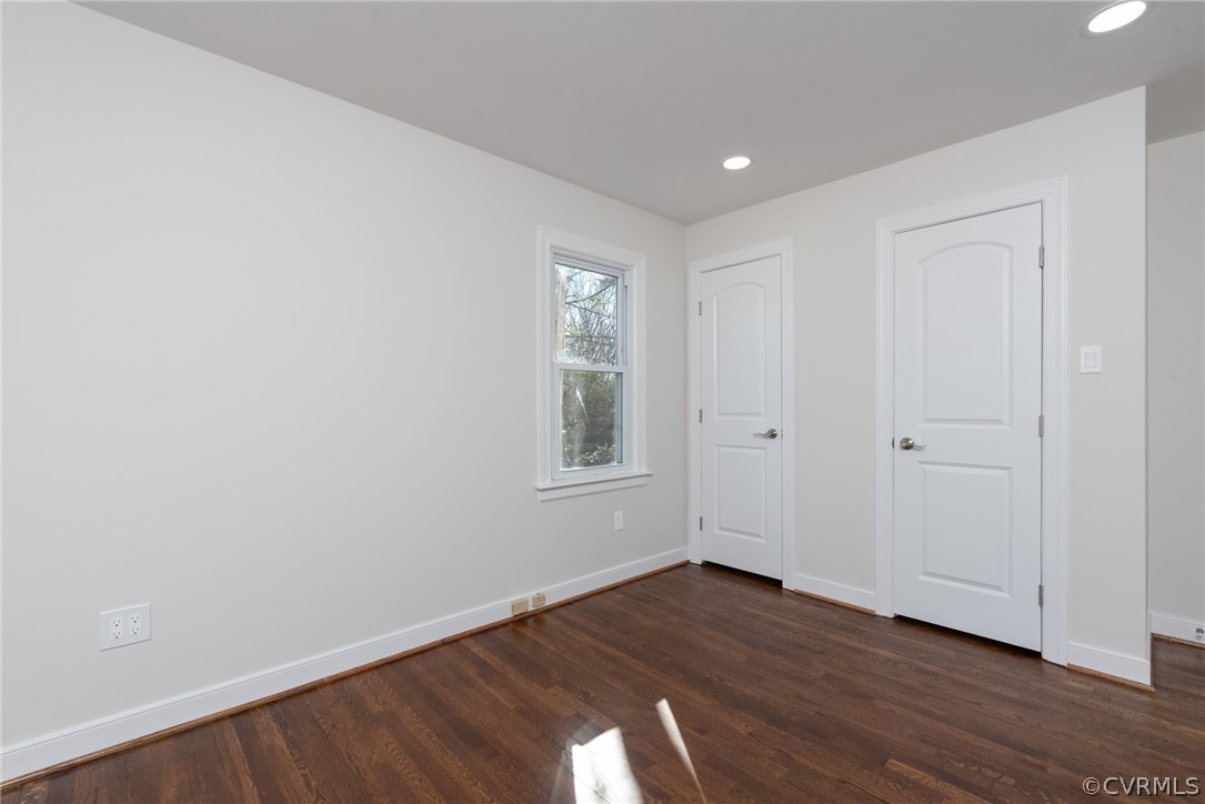11711 Robious Road Midlothian, VA 23113 - Photo 15 of 32 a view of an empty room with wooden floor and a window