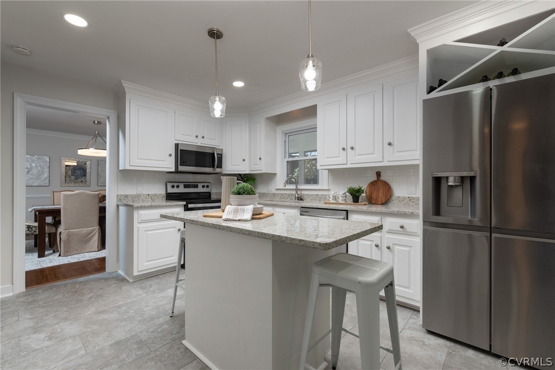 11711 Robious Road Midlothian, VA 23113 - Photo 9 of 32 a kitchen with stainless steel appliances a refrigerator stove microwave and cabinets