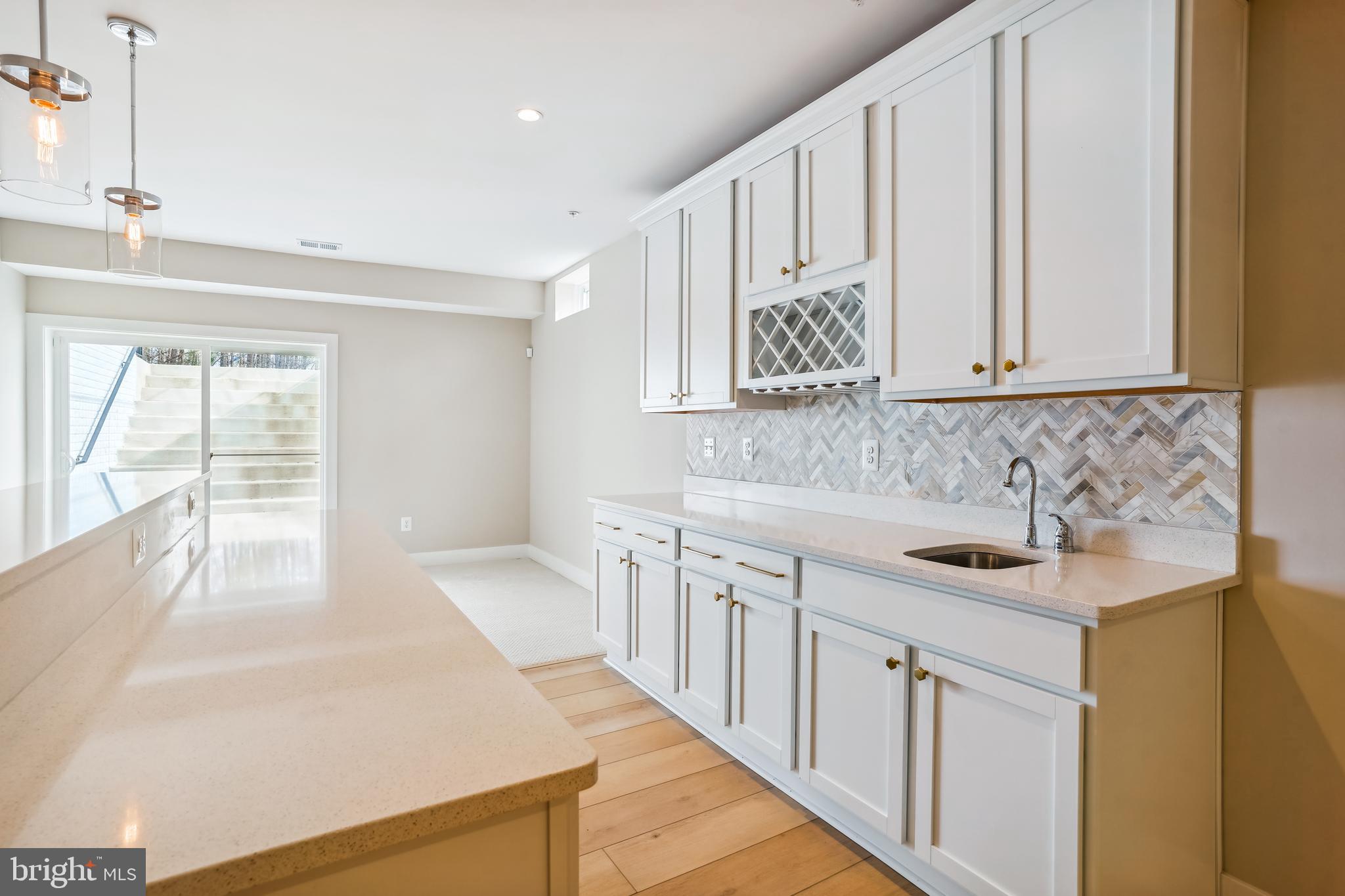 4996 Ilchester Road Ellicott City, MD 21043 - Photo 63 of 74 a kitchen with stainless steel appliances granite countertop white cabinets a sink and dishwasher