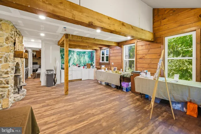 a living room filled with furniture and a wooden floor