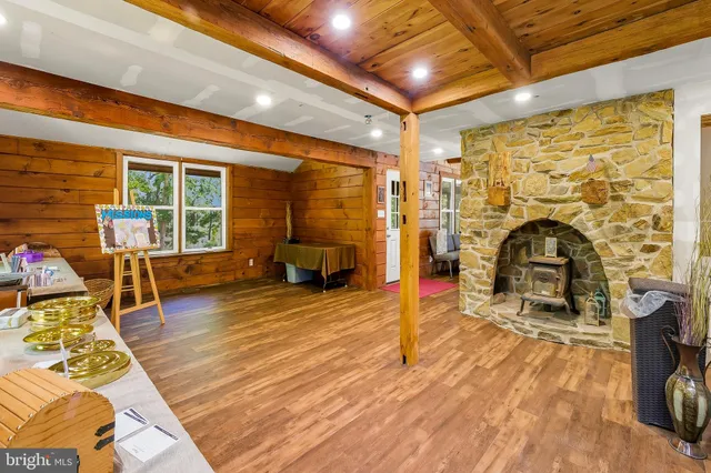 a living room with furniture a fireplace and wooden floor