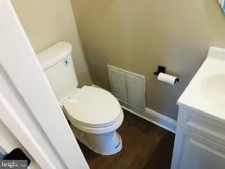 a view of a hallway with wooden floor and closet