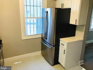 a view of a refrigerator and window in a kitchen