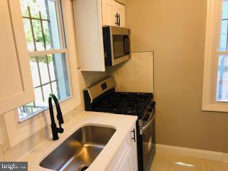 114 46th Street Southeast Washington, DC 20019 - Photo 7 of 21 a bathroom with a sink and a window
