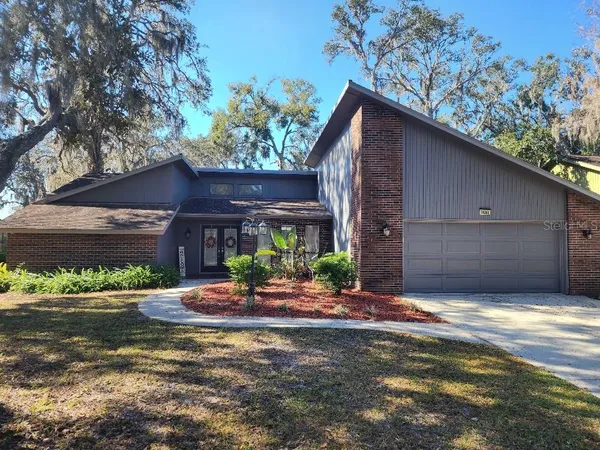 a view of a house with a yard and garage
