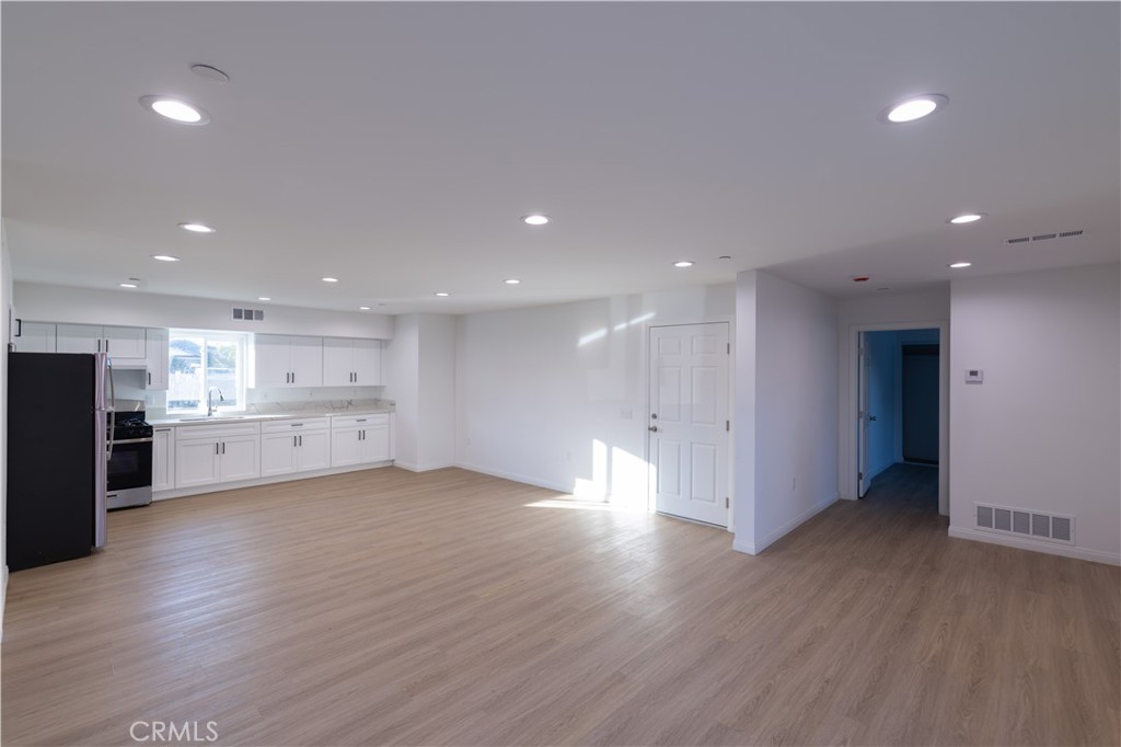 1202 West 3rd Street Santa Ana, CA 92703 - Photo 3 of 12 View of kitchen area that is open to living. Convenient direct access to the garage through door on the left.
