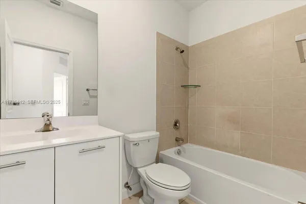 a bathroom with a toilet sink and shower