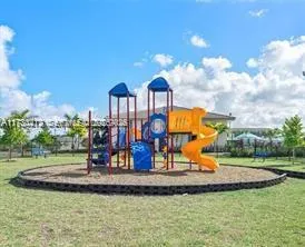 a view of a park with swings and slides