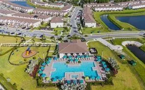 a view of swimming pool with a garden and plants
