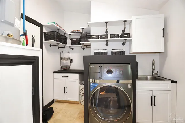 a view of washer and dryer with kitchen in the background