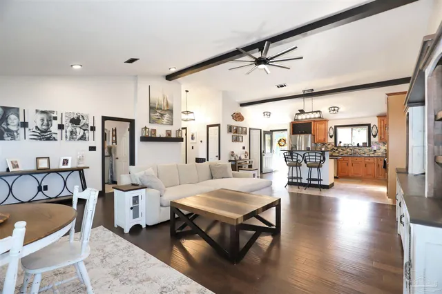 a living room with lots of furniture and kitchen view