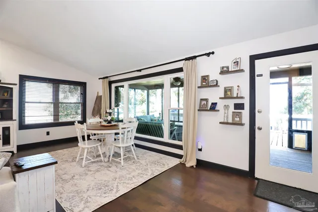 a dining room with furniture and window