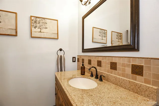 a bathroom with double vanity sink and a mirror