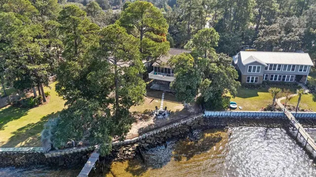 a view of a swimming pool with a patio and a yard