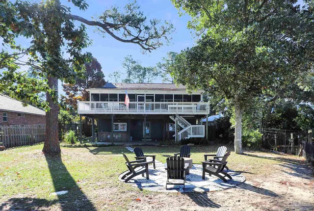 a terrace of a house with wooden floor outdoor seating