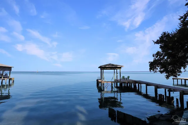 a view of a chairs and table on the deck