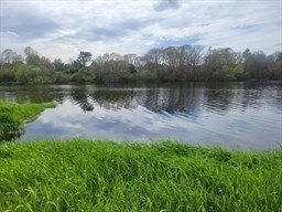 Lot 16-18 Old Fall River Road North Dartmouth, MA 02747 - Photo 5 of 6 a view of a lake with a yard and large trees
