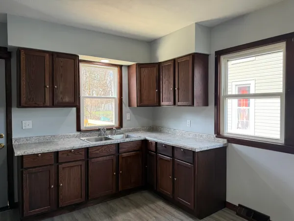 a kitchen with a sink cabinets and window