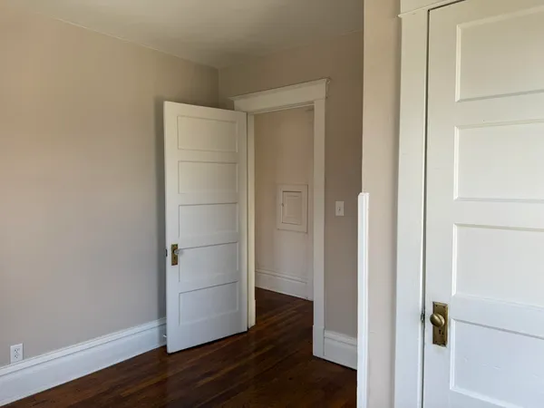 a view of walk in closet with wooden floor