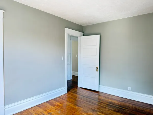 an empty room with wooden floor