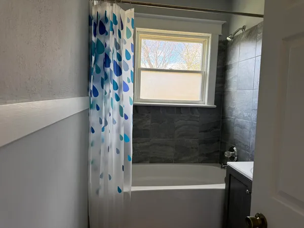a bathroom with a bathtub and shower