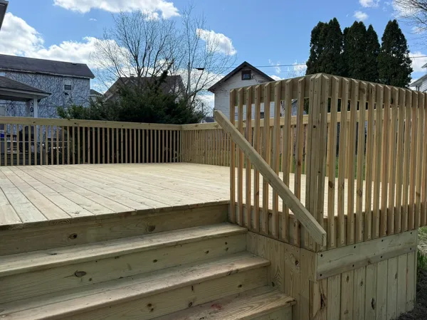 a view of balcony with wooden floor and fence