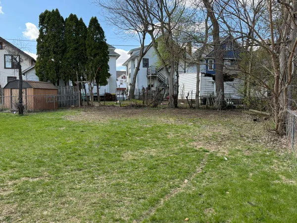 a tall house with a tree in front of it
